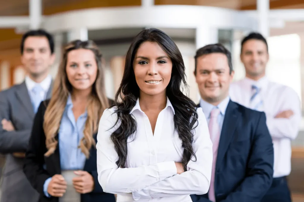 Business team posing with a woman in front
