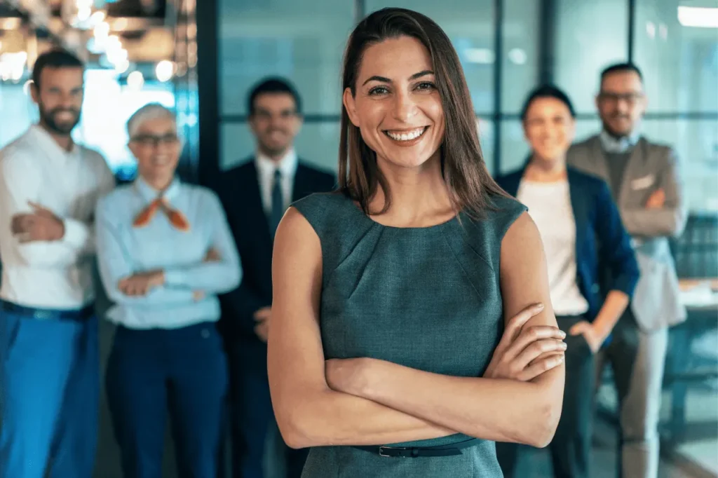 Business team with a smiling woman in front